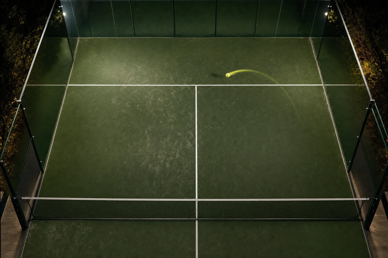 Night padel court with glass walls and service lines